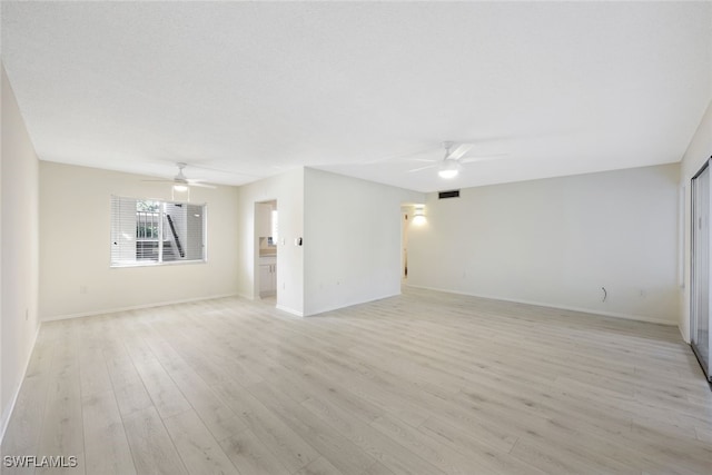 empty room featuring ceiling fan and light hardwood / wood-style floors