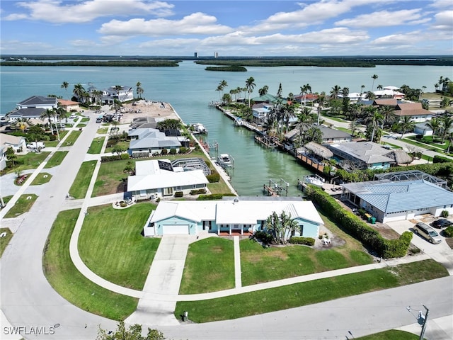 drone / aerial view featuring a residential view and a water view