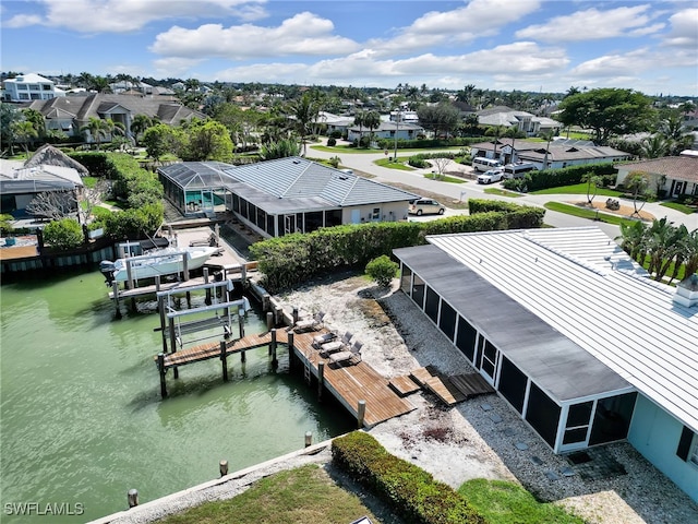 drone / aerial view featuring a water view and a residential view