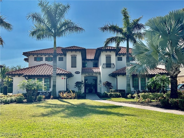 mediterranean / spanish-style house featuring a front yard