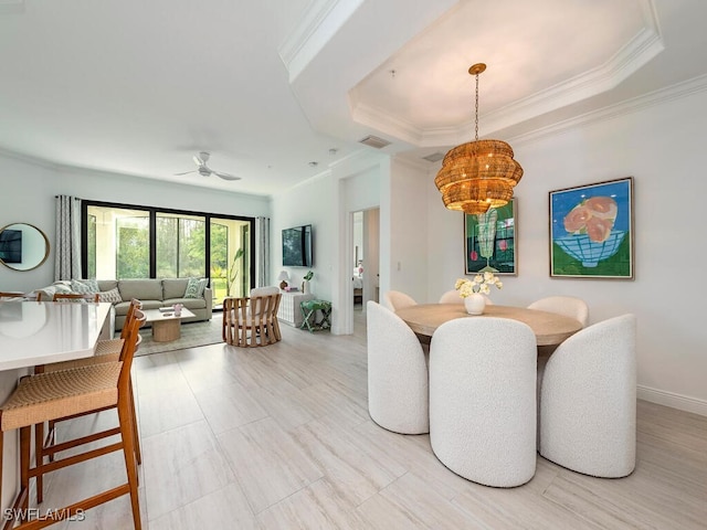 dining area featuring ceiling fan and ornamental molding