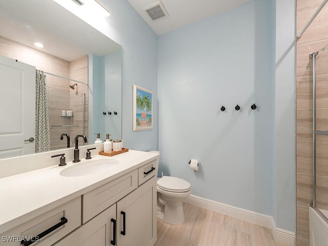 bathroom featuring wood-type flooring, toilet, vanity, and a shower with curtain