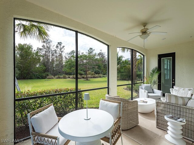 sunroom featuring ceiling fan