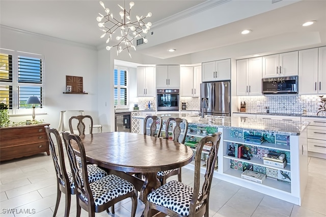 dining area featuring crown molding, recessed lighting, visible vents, an inviting chandelier, and beverage cooler