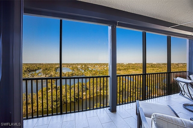 unfurnished sunroom with a water view and plenty of natural light