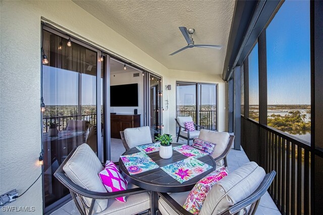 sunroom / solarium featuring ceiling fan