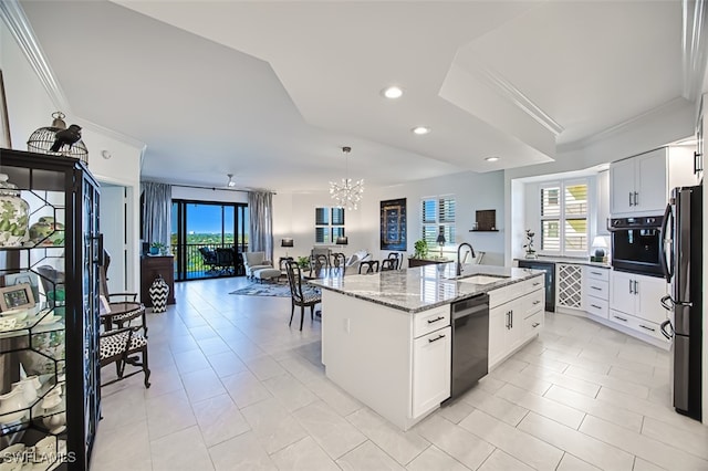 kitchen featuring black appliances, crown molding, a kitchen island with sink, and a sink