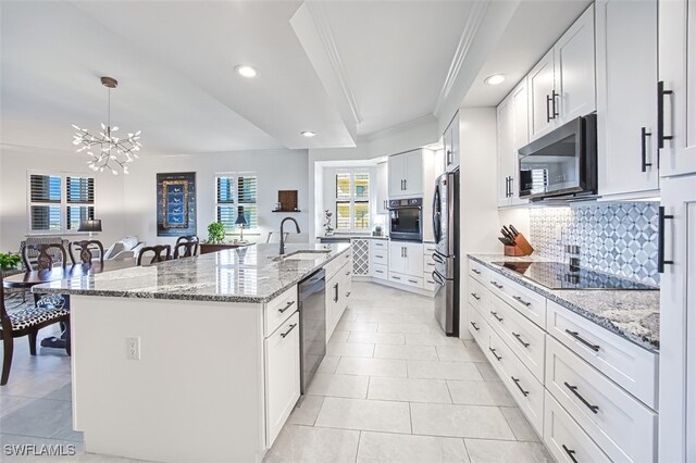 kitchen with white cabinetry, sink, a center island with sink, and black appliances