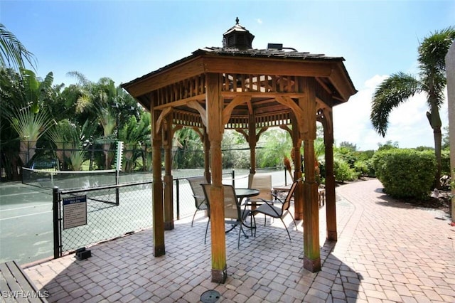 view of home's community featuring tennis court and a gazebo