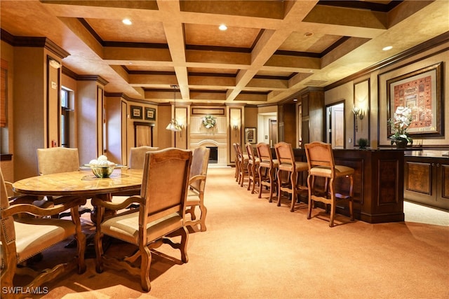 carpeted dining space with beam ceiling, wood walls, ornamental molding, and coffered ceiling