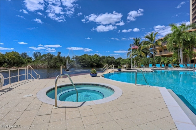 view of swimming pool with a hot tub