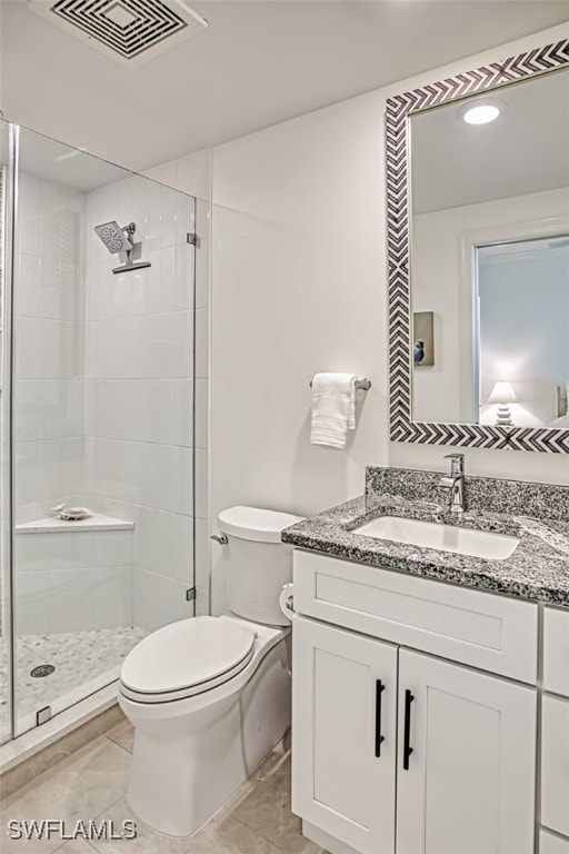 full bathroom featuring visible vents, a stall shower, vanity, and toilet