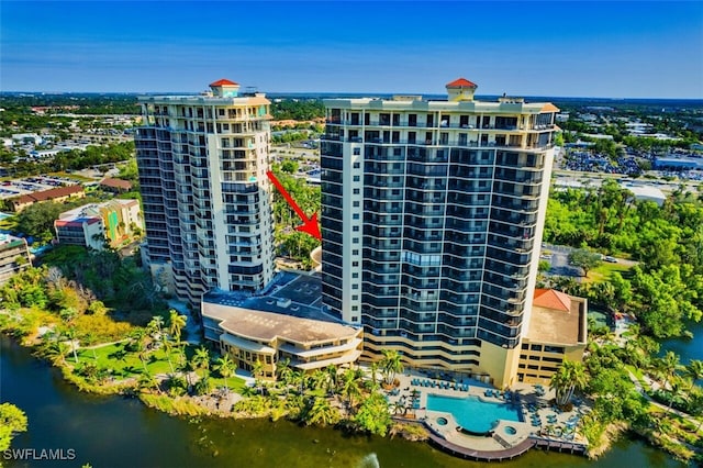 birds eye view of property with a view of city and a water view