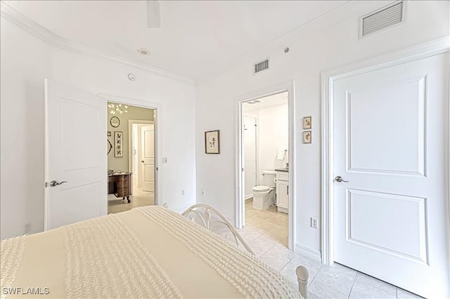 bedroom with ornamental molding, visible vents, connected bathroom, and baseboards