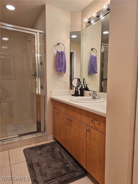 bathroom with vanity, tile patterned flooring, and walk in shower