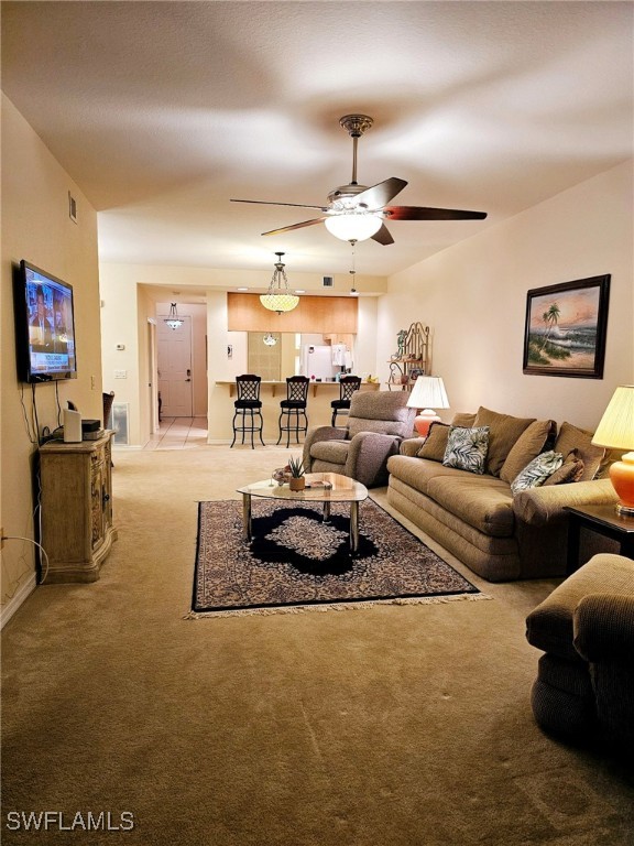 living room with ceiling fan and light carpet