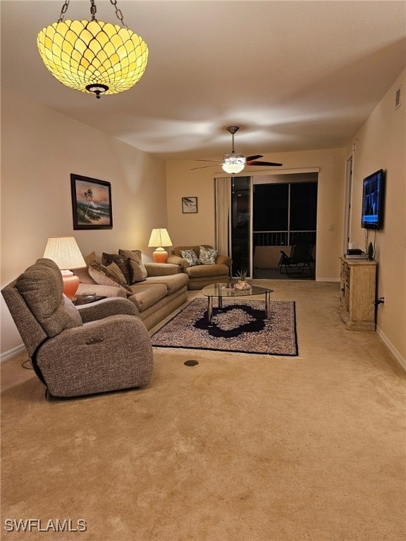 carpeted living room featuring ceiling fan