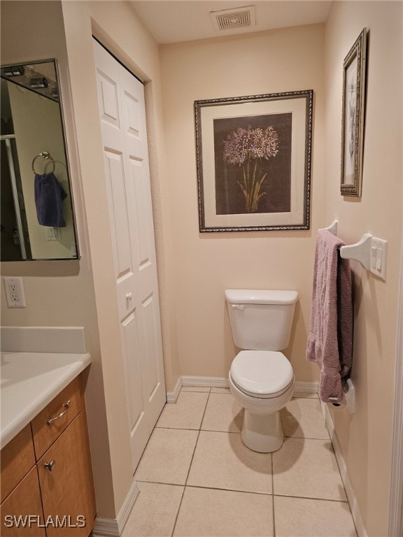 bathroom featuring tile patterned flooring, vanity, and toilet