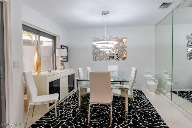 dining space featuring a chandelier and tile patterned flooring