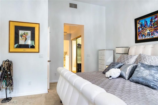 bedroom with light colored carpet and a closet