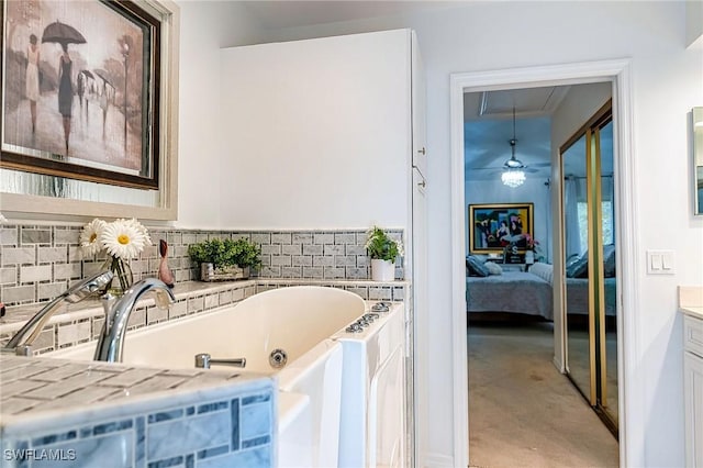 bathroom featuring ceiling fan, concrete floors, vanity, and a bath