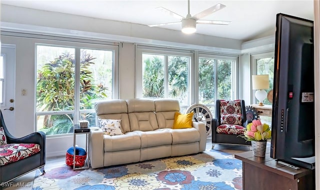 sunroom featuring ceiling fan and a healthy amount of sunlight