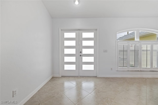 foyer with french doors and light tile patterned floors