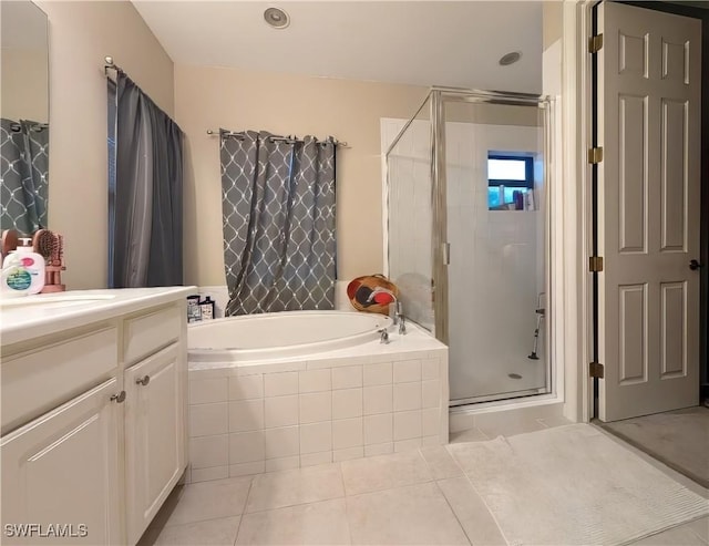 bathroom with tile patterned floors, vanity, and shower with separate bathtub