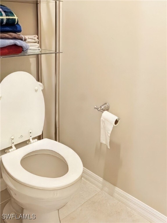 bathroom with toilet and tile patterned floors