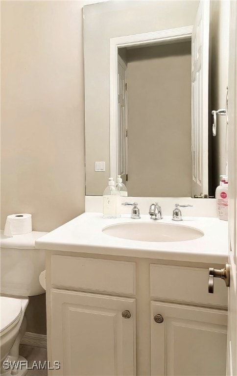 bathroom with toilet and vanity