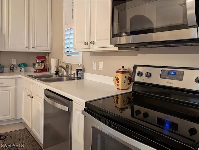 kitchen featuring sink, white cabinetry, and appliances with stainless steel finishes