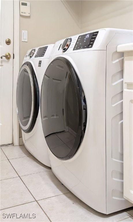 laundry room with tile patterned flooring and washer and dryer