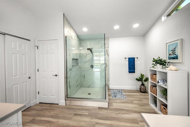 bathroom featuring a shower with door and wood-type flooring