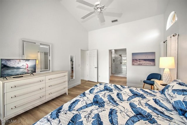 bedroom with ceiling fan, light hardwood / wood-style floors, and high vaulted ceiling