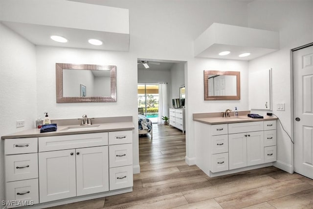 bathroom with vanity, hardwood / wood-style floors, and ceiling fan