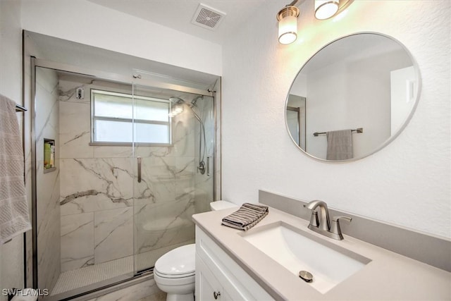 bathroom featuring an enclosed shower, vanity, and toilet