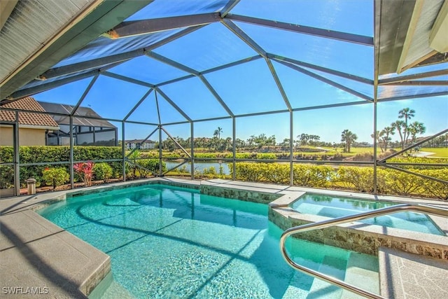 view of swimming pool with an in ground hot tub, glass enclosure, and a water view