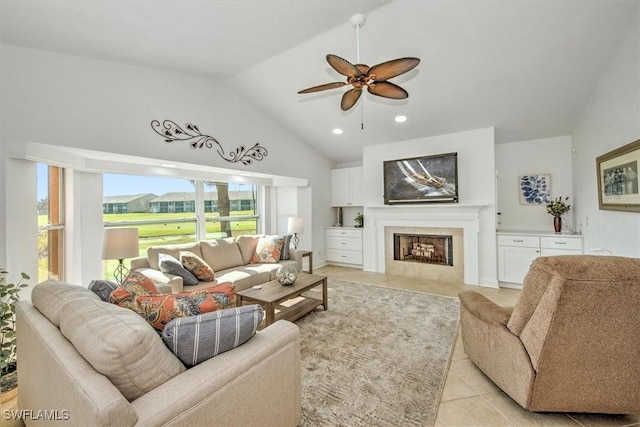 living room featuring lofted ceiling, ceiling fan, and light tile patterned floors