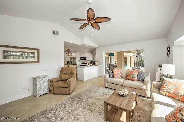 living room featuring ceiling fan, lofted ceiling, and light tile patterned floors