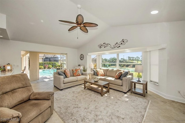 tiled living room with lofted ceiling, ceiling fan, and a wealth of natural light