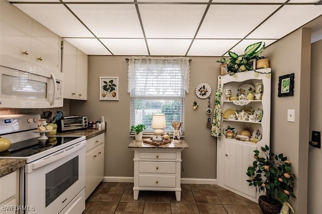 kitchen with white cabinetry and white appliances