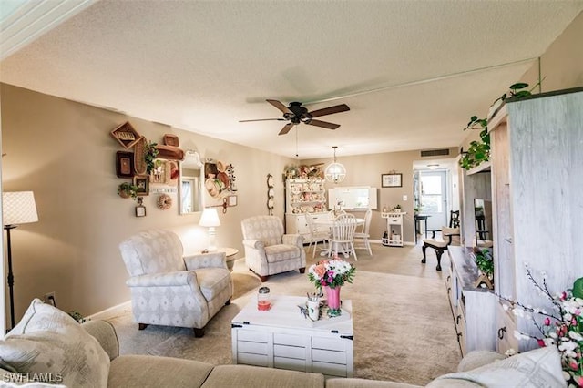 living room with a textured ceiling, ceiling fan, and light carpet