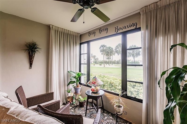 sunroom / solarium featuring ceiling fan