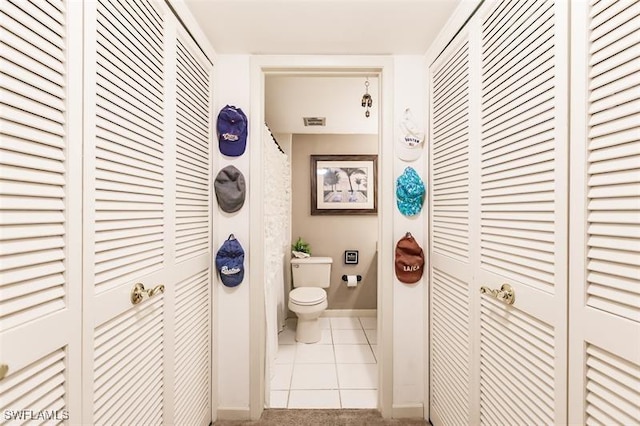 bathroom featuring toilet and tile patterned floors