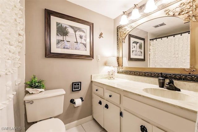 bathroom with tile patterned floors, vanity, and toilet