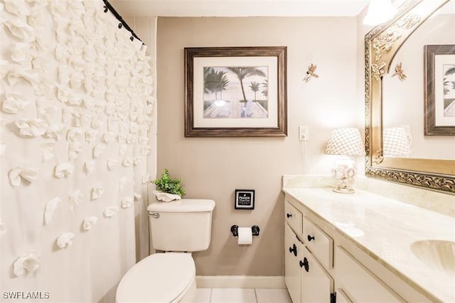 bathroom with tile patterned floors, vanity, and toilet