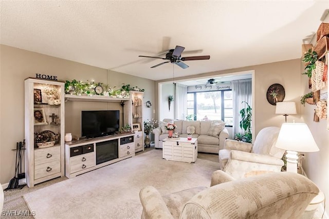 carpeted living room with ceiling fan