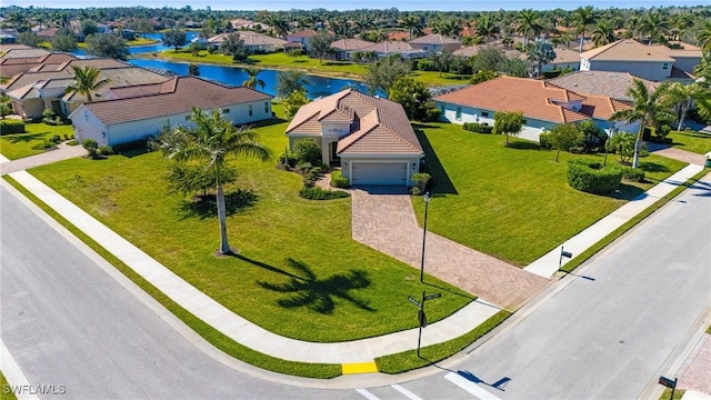 bird's eye view featuring a water view and a residential view