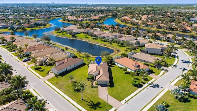 drone / aerial view with a residential view and a water view