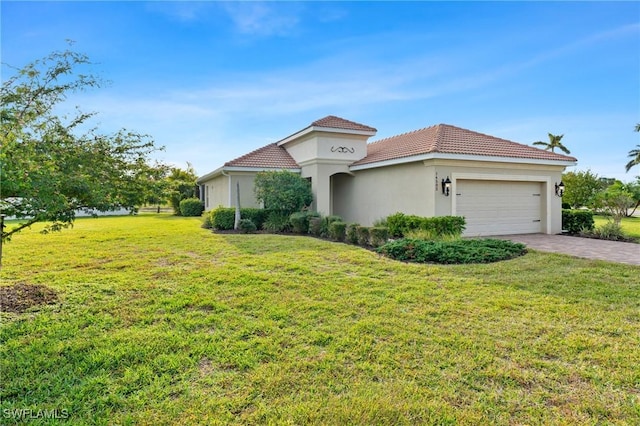 mediterranean / spanish home featuring an attached garage, decorative driveway, a front yard, and stucco siding